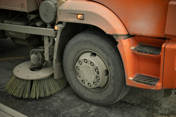 Cleaning road. Brush for asphalt. Washing transport in city.