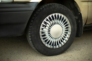 Car wheel. Hubcap on wheel. Vehicle tuning details. Drive wheel. Retro style.