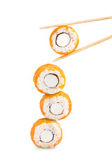 Balancing creative healthy philadelphia rolls a type of sushi made of raw salmon fish, boiled rice, cream cheese and nori seaweed eaten with wooden bamboo chopsticks isolated on white background