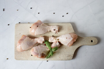 Fototapeta premium Raw chicken legs with spices and herbs. on a white background. food