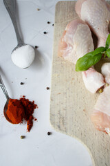 Raw chicken legs with spices and herbs. on a white background. food