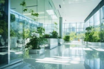 Blurred background of modern glass office, hall of business center, shopping center, bank with living green plants. Business concept, modern bright interior