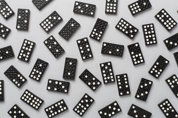 Black domino tiles on color background, top view