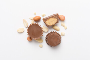 Tasty chocolate peanut butter cups on color background, top view