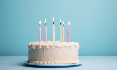birthday cake with  six 6 candles on pastel blue background with copyspace