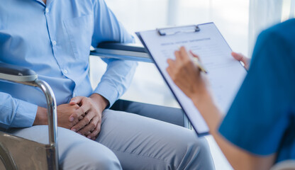 Doctor and patient sitting and talking at medical examination at hospital office, close-up. Therapist filling up medication history records. Medicine and healthcare concept. - obrazy, fototapety, plakaty
