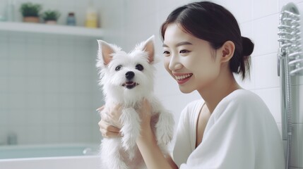 Content young Asian woman playing ball games with her adorable, fluffy Jack Russell terrier puppies...