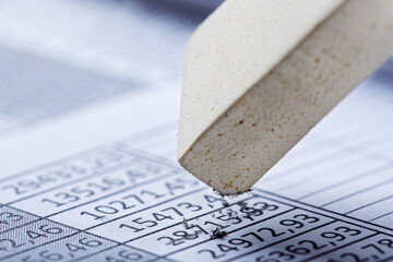 Fix with eraser financial data in document. Concept of banking, financial report and financial...