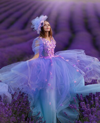 Beautiful provence woman relaxing in lavender field watching on sunset holding basket with lavanda...
