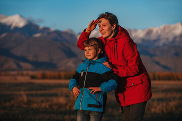 Mother and son looking out into the mountains in the evening