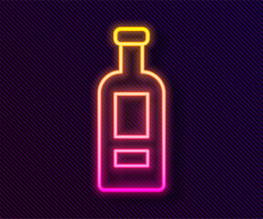 Glowing neon line Glass bottle of vodka icon isolated on black background. Vector