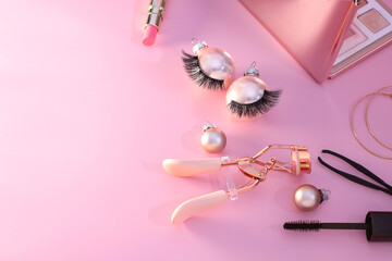 False eyelashes and curler tool cosmetics, Christmas decoration, pinkbackground