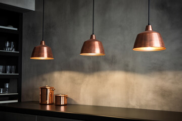 Modern lamps with copper metal shades in a contemporary industrial loft kitchen