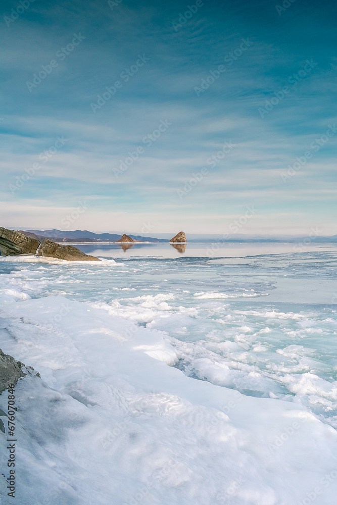 Wall mural Sea winter landscape. Sea slush and ice floes on the sea surface in winter during sunset. Fabulous winter day by the sea.