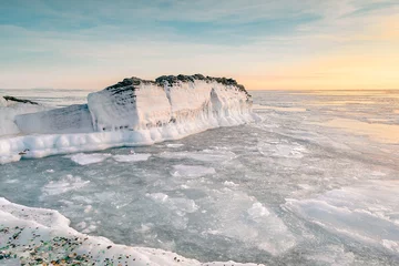 Foto auf Acrylglas Sea winter landscape. Sea slush and ice floes on the sea surface in winter during sunset. Fabulous winter day by the sea. © Tishina