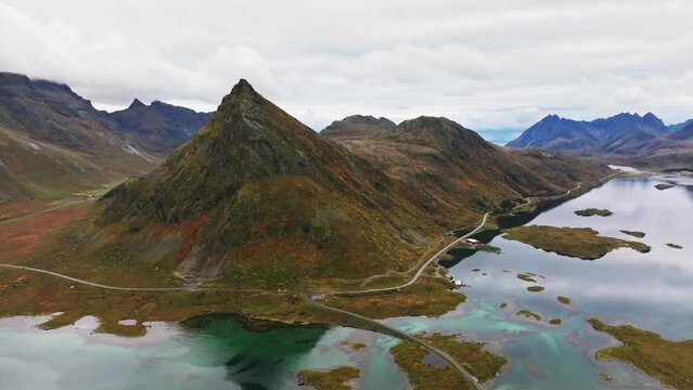 Aerial Majesty: Gazing Over a Lofoten Hill, Unveiling the Vast Ocean and Towering Mountain Peaks in Norway