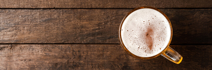 Beer glass on an old wooden table. Top view