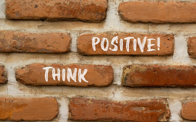 Think positive symbol. Concept words Think positive on beautiful brown bricks. Beautiful brick wall background. Beautiful brick wall. Business, motivational think positive thinking concept. Copy space