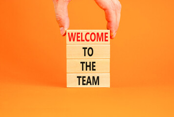 Welcome to the team symbol. Concept words Welcome to the team on wooden block. Beautiful orange...