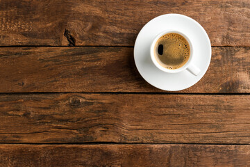 Coffee cup on vintage wooden table with copyspace. Top view
