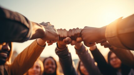 Multiracial group of young people making fist bump as symbol of unity, Community and solidarity.