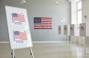 Interior of an empty election station in the United States of America. White office board with VOTE...