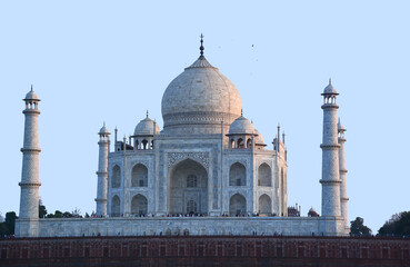 Taj Mahal at sunrise is an ivory-white marble mausoleum on the right bank of the river Yamuna in...