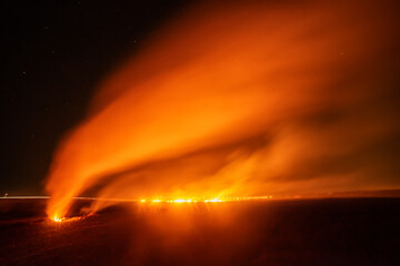 Fire in the field. Burning dry grass on the field. Night fire in the field. Burning grass in a...