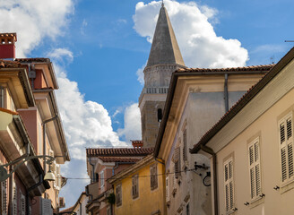 Streets of the old town of Koper with the Cathedral of the Assumption bell tower in the background,...