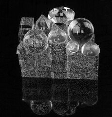 transparent glass geometric shapes and cubes on a black background