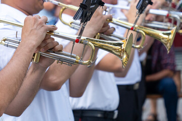 Military musicians play trumpets at a festival