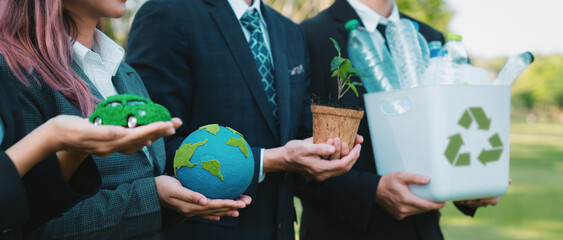 Group of businesspeople volunteer to promote Earth Day and environmental friendly, embracing ESG or Environmental, Social, and Governance practice to contribute greener environment sustainability.Gyre - obrazy, fototapety, plakaty