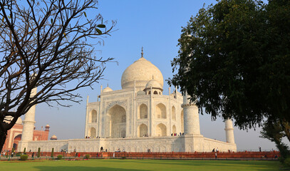 Fototapeta na wymiar The Taj Mahal at sunrise is an ivory-white marble mausoleum on the right bank of the river Yamuna in Agra 