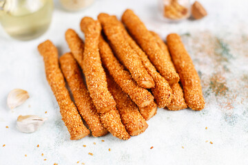 Italian grissini or salted bread sticks with sesame seeds.