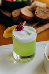 Tasty cocktail is standing on restaurant table. Alcohol drink menu