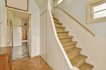 a staircase leading up to the second floor in a new home with wood floors and white panelling on the walls