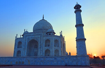 Taj Mahal at sunrise is an ivory-white marble mausoleum on the right bank of the river Yamuna in...