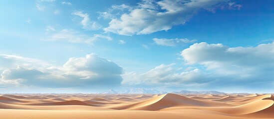 Fototapeta na wymiar The blue sky gracefully stretches across the vast Sahara desert offering a breathtaking backdrop to the stunning landscape of golden dunes as a long road leads through the arid wilderness s