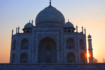 Fototapeta na wymiar Taj Mahal at sunrise is an ivory-white marble mausoleum on the right bank of the river Yamuna in Agra India