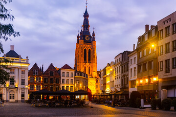 Fototapeta na wymiar Night view of medieval gothic Saint Martins church and old buildings on Grote Markt, main square of Kortrijk, Belgium