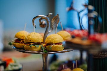 
Close up of mini hamburgers at catering event.