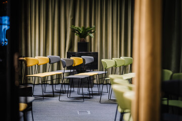 A row of office chairs set up for a press conference.