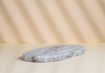 Abstract empty marble board with shadows on a beige background. Layout concept for promotional product presentation, sale or cosmetics display.