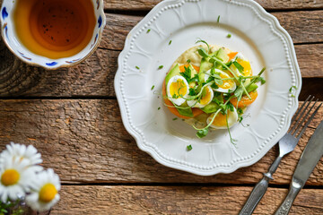 Potato cutlet with yellow tomatoes, peas, cheese and quail eggs.