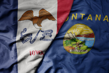 big waving colorful national flag of montana state and flag of iowa state .