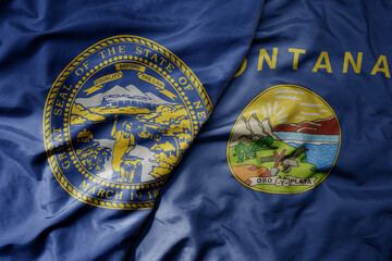 big waving colorful national flag of montana state and flag of nebraska state .