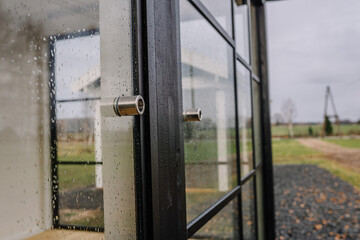 Blurred rain drops through glass door