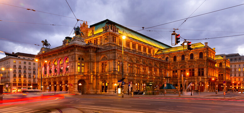 Scenic view of Vienna cityscape overlooking central avenue and neo-Renaissance building of State Opera with evening illumination in winter, Austria.