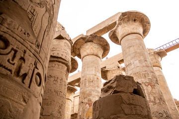 ancient Egyptian hieroglyphs on massive columns of hippostyle hall in karnak temple in luxor, egypt