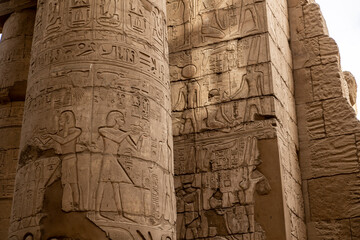 ancient Egyptian hieroglyphs on massive columns of hippostyle hall in karnak temple in luxor, egypt